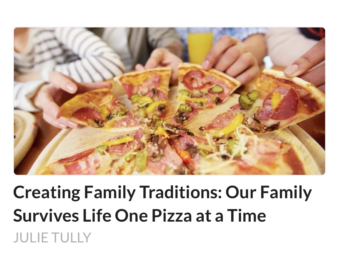 several hands reaching for slices of a large pizza