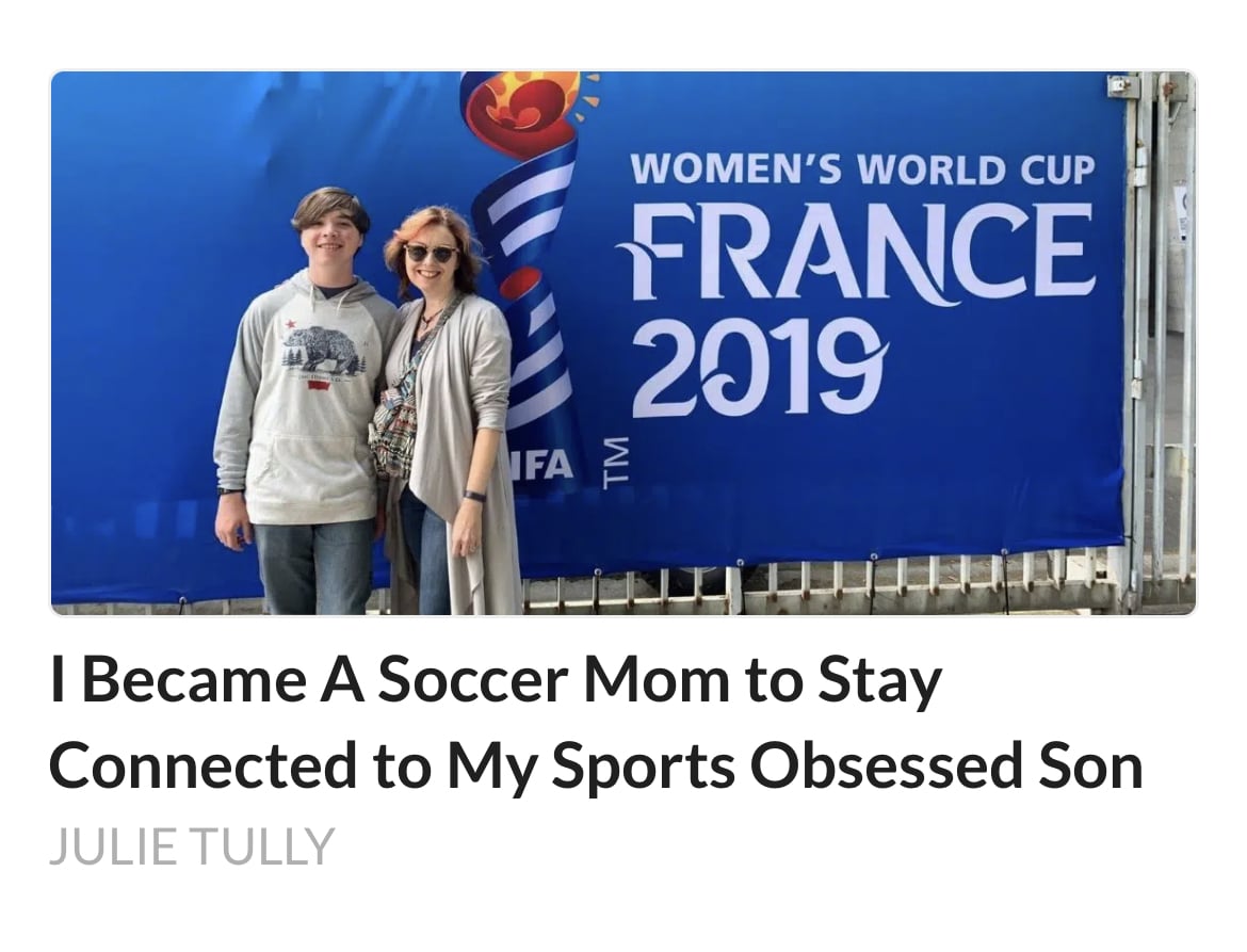 Julie Tully and her son in front of a France Womens World Cup 2019 banner